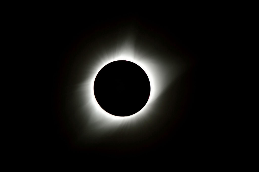 Total solar eclipse during full totality with the Sun’s corona visible around the Moon’s silhouette.